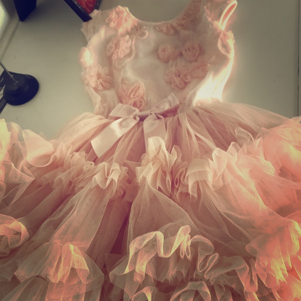 Peach colored riffled dress for girls.